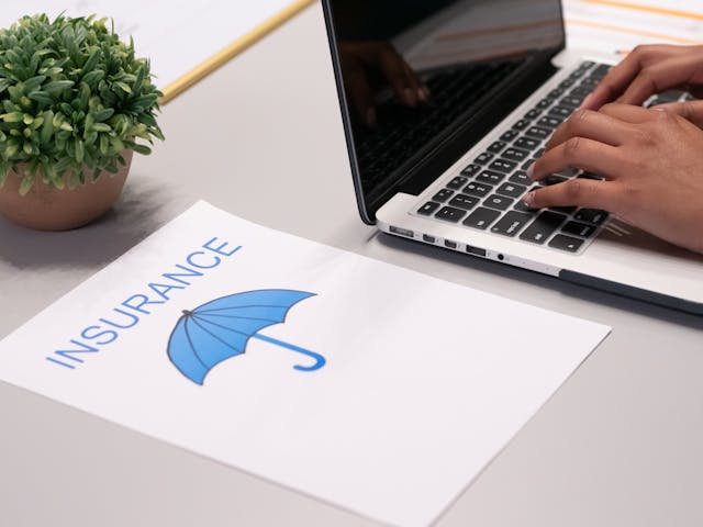 a paper with the word insurance and an image of an umbrella on it