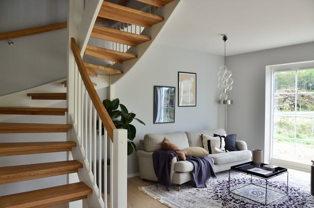 a small living room off of a winding staircase